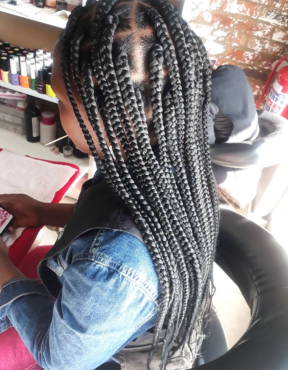 Long medium box braids with neat parts, done at Afrocentrix